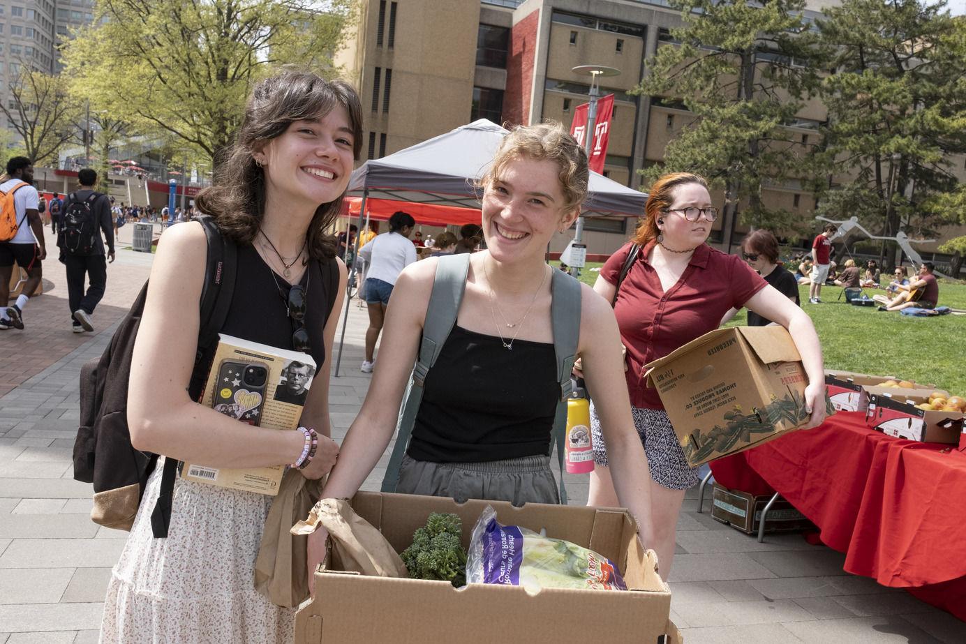 An image of two students smiling after the Share Fair event.
